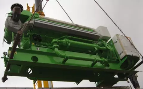 Electrical technician looking focused while working in a switchboard with fuses.
