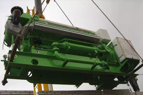 Electrical technician looking focused while working in a switchboard with fuses.